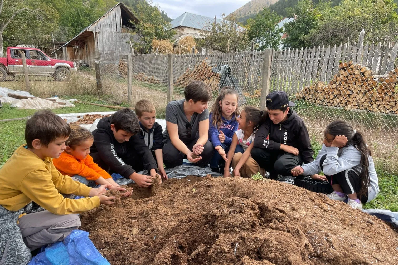 Lurë kids getting their hands dirty on the substrate, before planting seeds